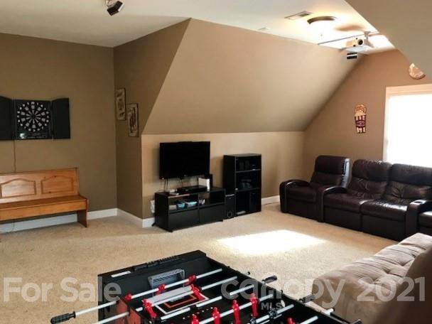 1912 Riverbank Road Waxhaw, NC 28173 - Photo 15 of 19 a living room with furniture and a flat screen tv