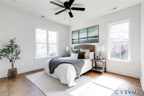 a spacious bedroom with a bed and a window