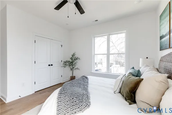 a spacious bedroom with a bed and a window
