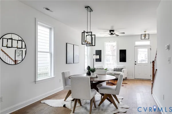 a view of a dining room with furniture window and wooden floor
