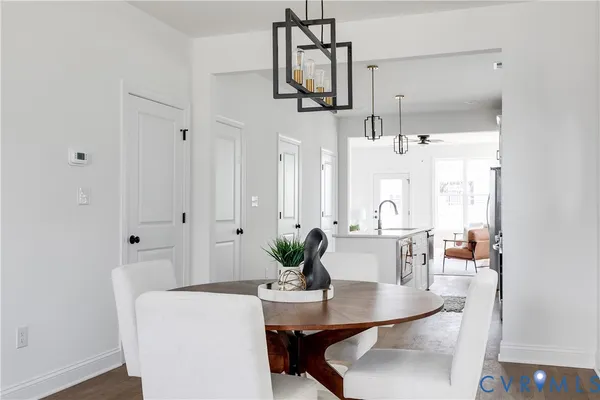 a dining room with furniture and wooden floor