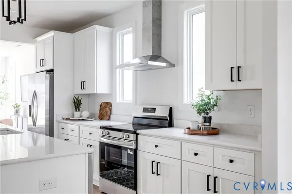 a kitchen with stainless steel appliances white cabinets and a stove