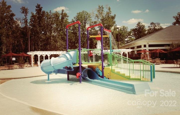 4043 Oakmere Road, Unit 953 Waxhaw, NC 28173 - Photo 21 of 21 a view of a patio with swimming pool and sitting area