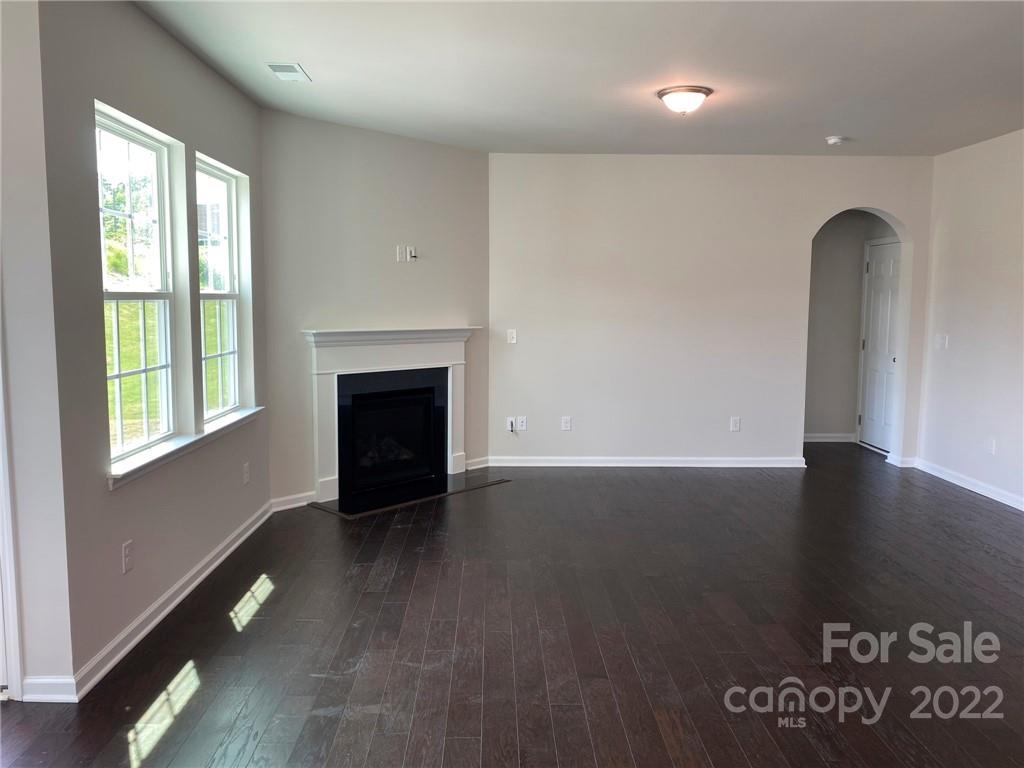 4043 Oakmere Road, Unit 953 Waxhaw, NC 28173 - Photo 9 of 21 an empty room with wooden floor and windows