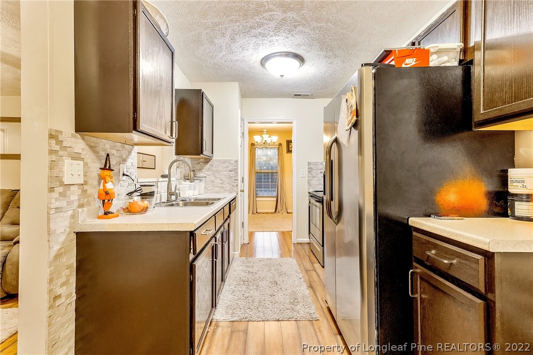 370 Sawyer Road Cameron, NC 28326 - Photo 5 of 26 a kitchen with stainless steel appliances granite countertop a sink and refrigerator