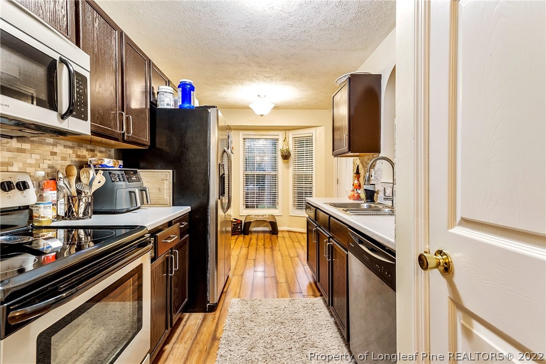 370 Sawyer Road Cameron, NC 28326 - Photo 6 of 26 a kitchen with stainless steel appliances granite countertop a stove and a sink