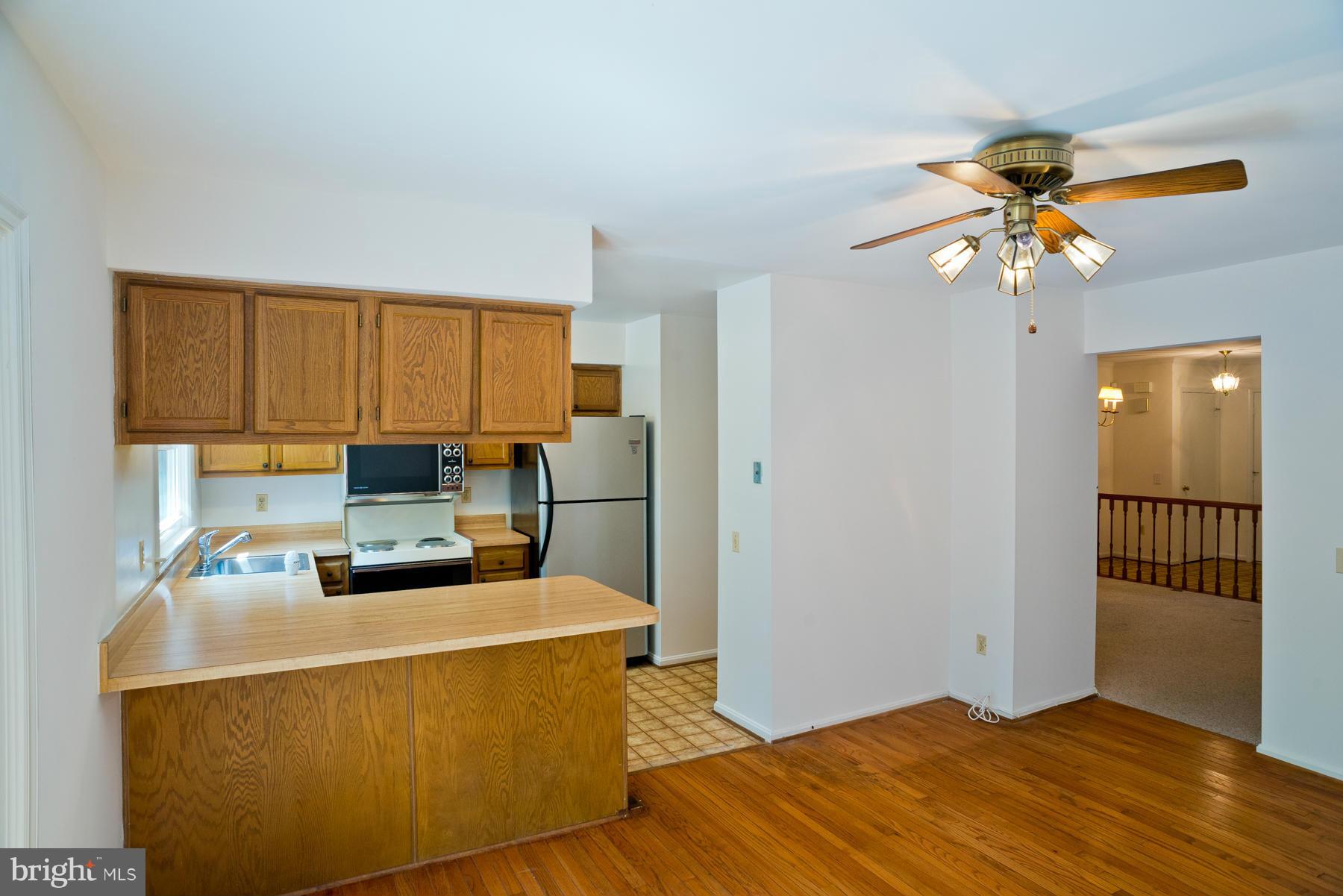 325 Crescendo Way Silver Spring, MD 20901 - Photo 12 of 21 a living room with a couch and a chandelier