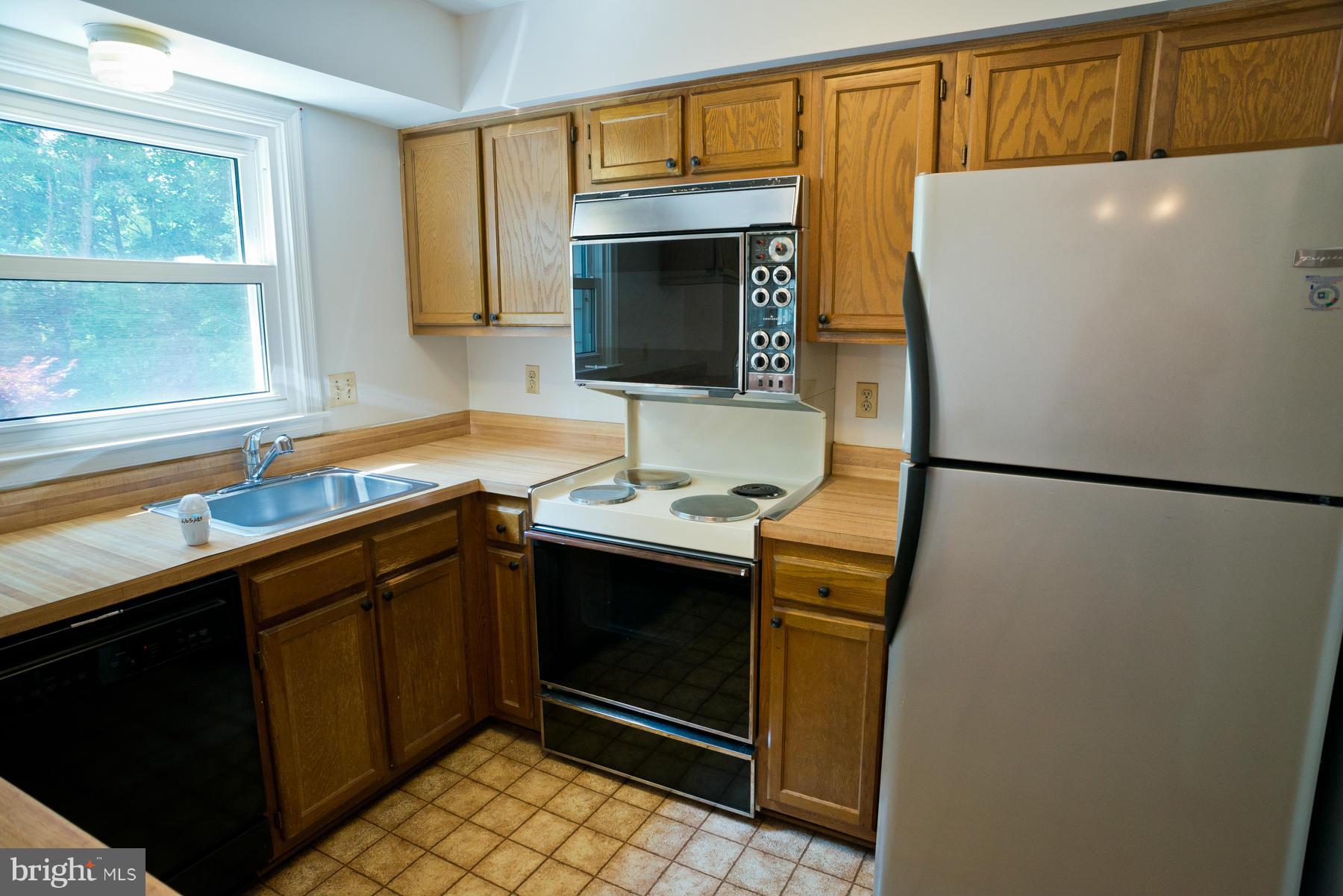 325 Crescendo Way Silver Spring, MD 20901 - Photo 15 of 21 a kitchen with stainless steel appliances a refrigerator sink and cabinets