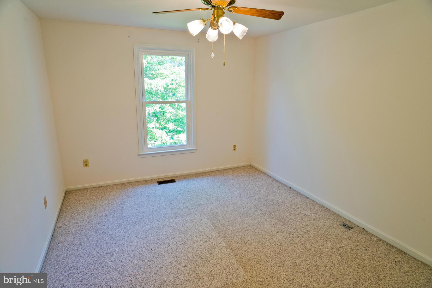 325 Crescendo Way Silver Spring, MD 20901 - Photo 19 of 21 an empty room with a window and a fan