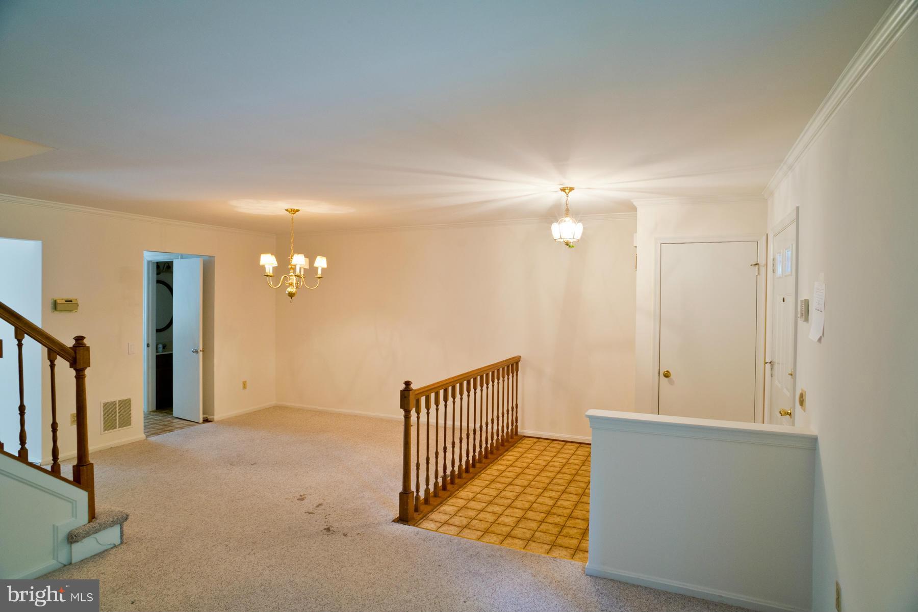 325 Crescendo Way Silver Spring, MD 20901 - Photo 5 of 21 a view of hallway with stairs and wooden floor