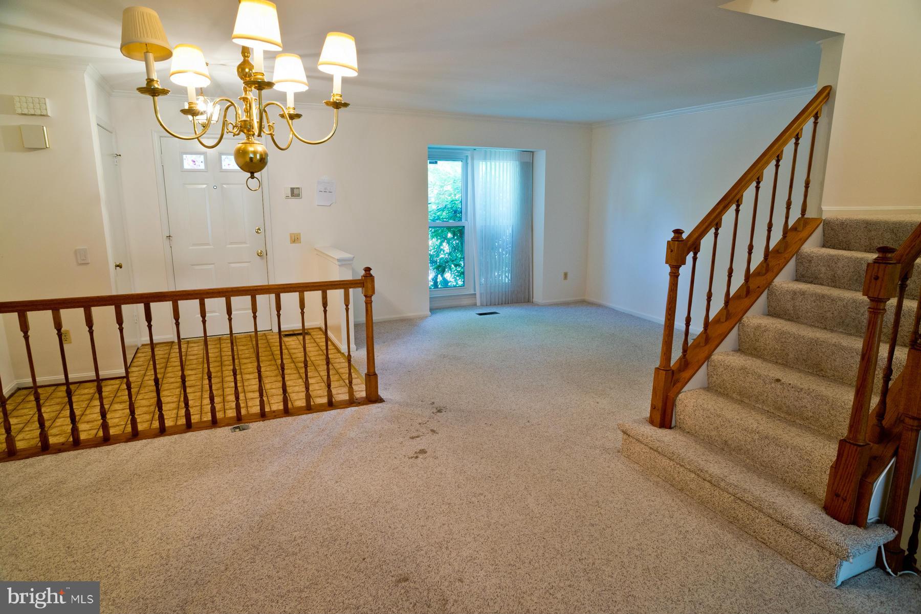 325 Crescendo Way Silver Spring, MD 20901 - Photo 8 of 21 a view of stairs and hall with wooden floor