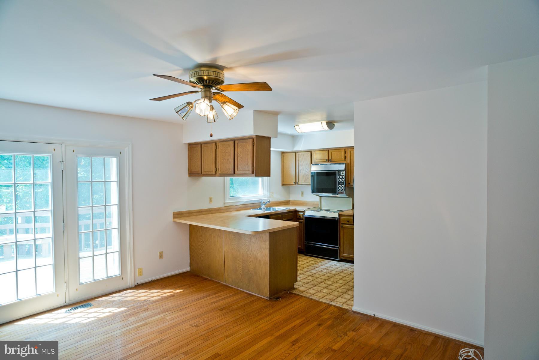 325 Crescendo Way Silver Spring, MD 20901 - Photo 9 of 21 a kitchen with stainless steel appliances granite countertop a stove and a refrigerator