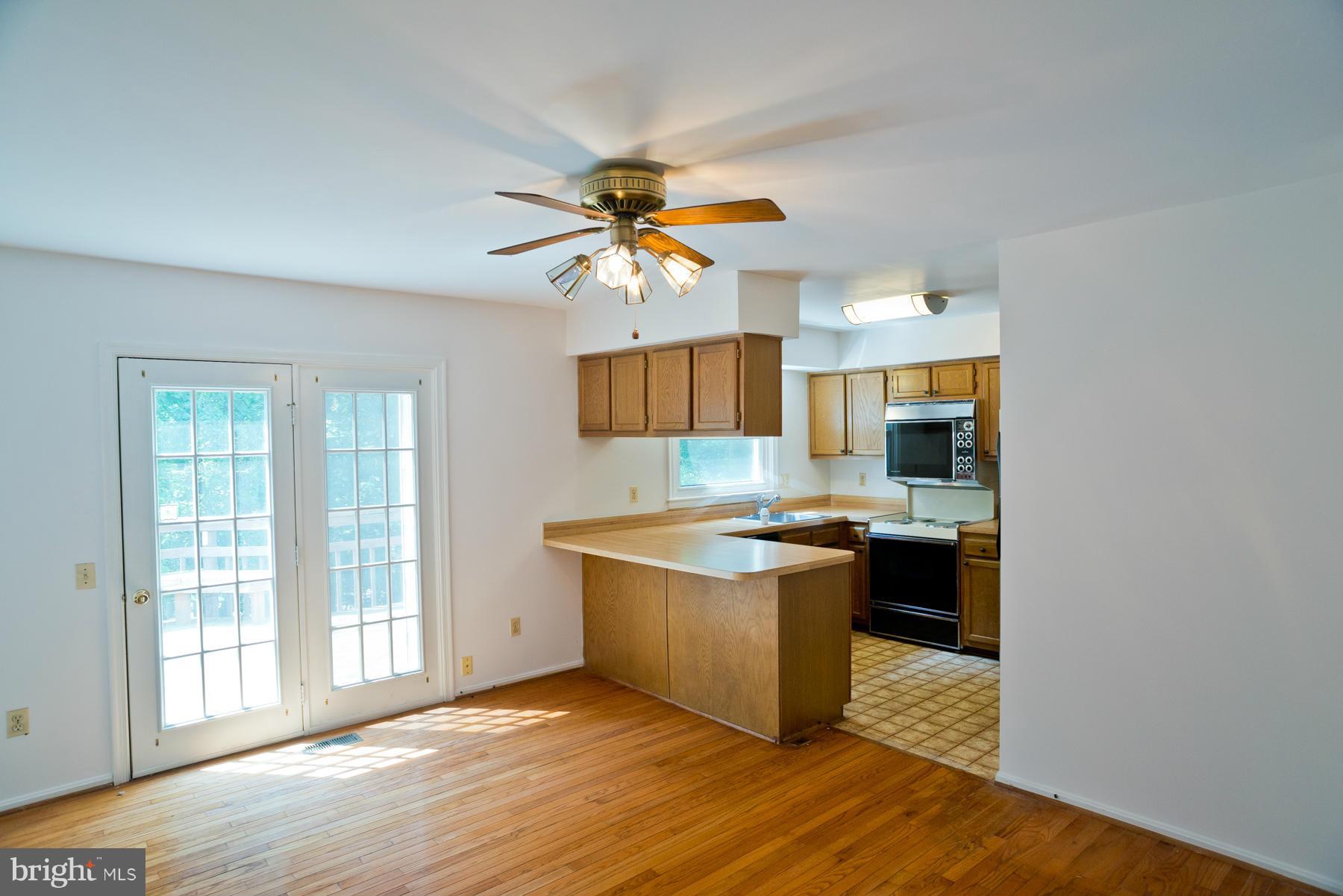 325 Crescendo Way Silver Spring, MD 20901 - Photo 10 of 21 a kitchen with stainless steel appliances a sink and a stove