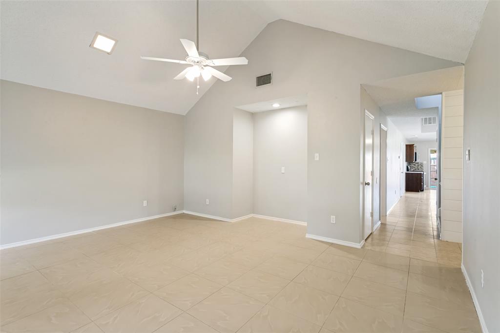 1712 East Peters Colony Road Carrollton, TX 75007 - Photo 14 of 25 Spacious room featuring a vaulted ceiling with a ceiling fan, recessed lighting, and neutral-toned tile flooring