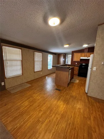 a view of kitchen and wooden floor