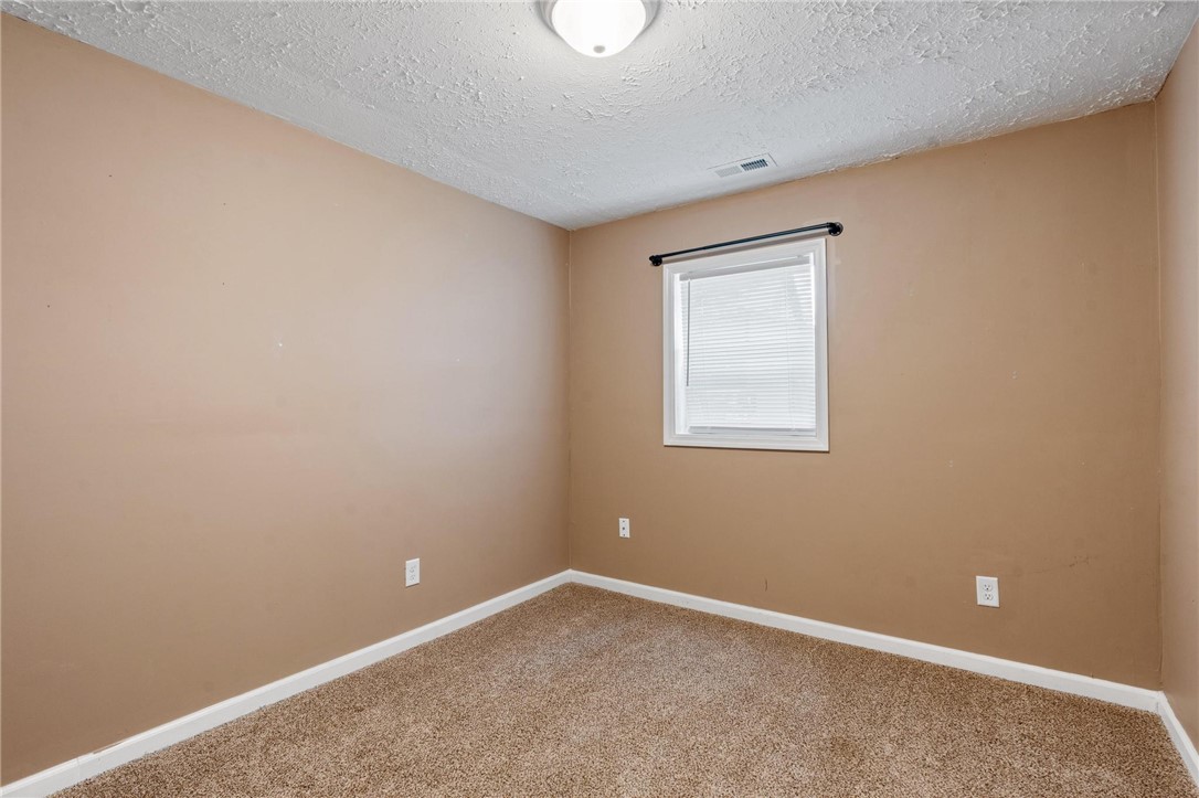 885 Hook Road Xenia, OH 45385 - Photo 16 of 33 This cozy bedroom features plush carpeting and a bright window, creating a comfortable living space.