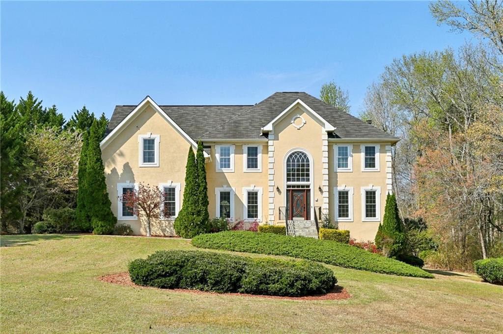 a front view of a house with a yard