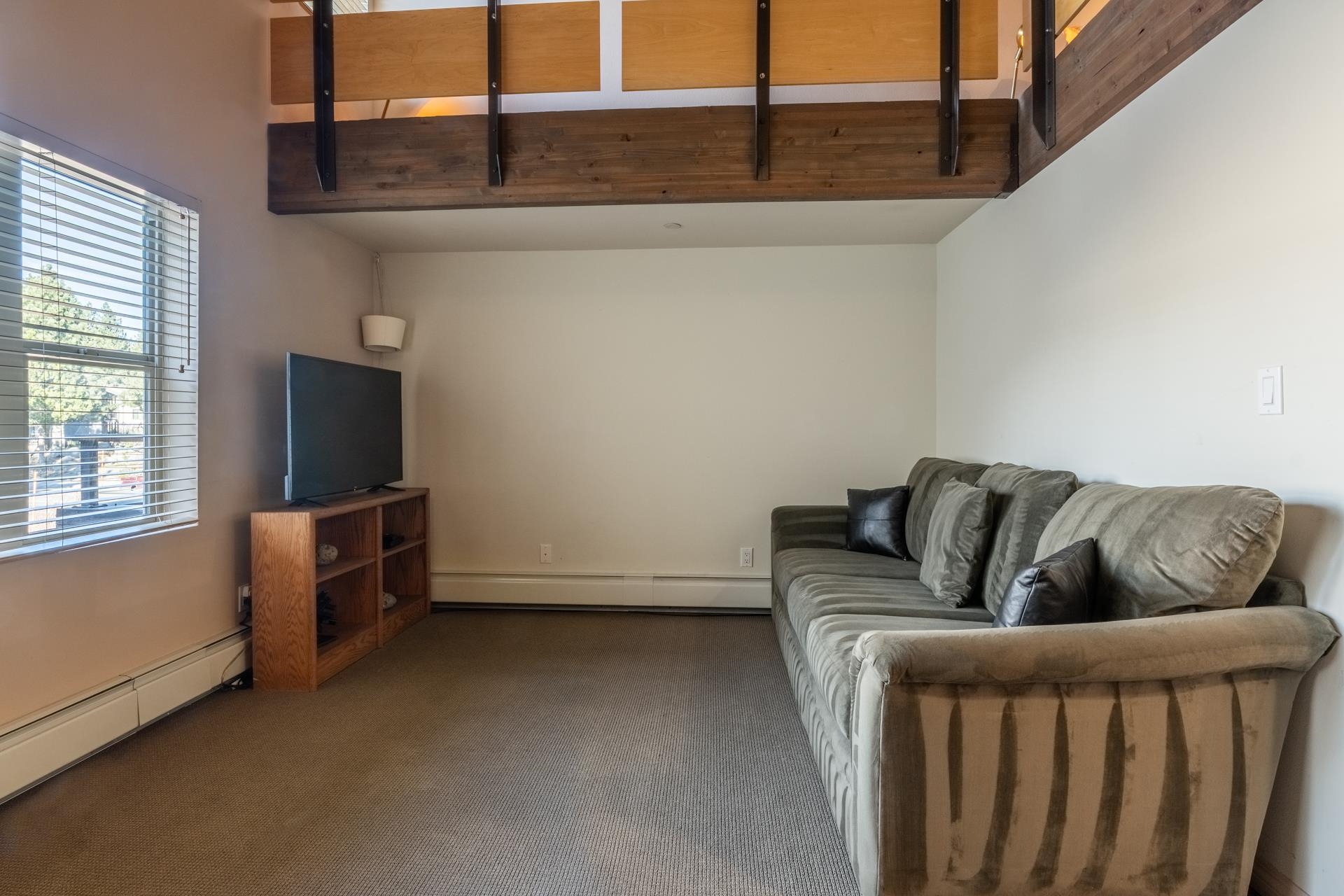 436 Old Mammoth Road, Unit 1 Mammoth Lakes, CA 93546 - Photo 8 of 23 a living room with furniture and a flat screen tv