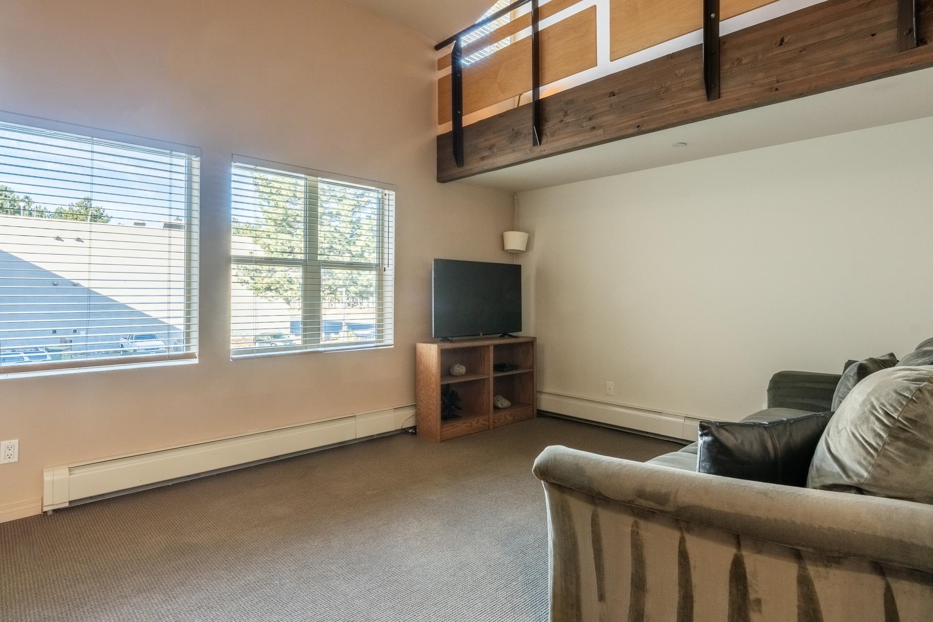 436 Old Mammoth Road, Unit 1 Mammoth Lakes, CA 93546 - Photo 10 of 23 a living room with furniture and a flat screen tv