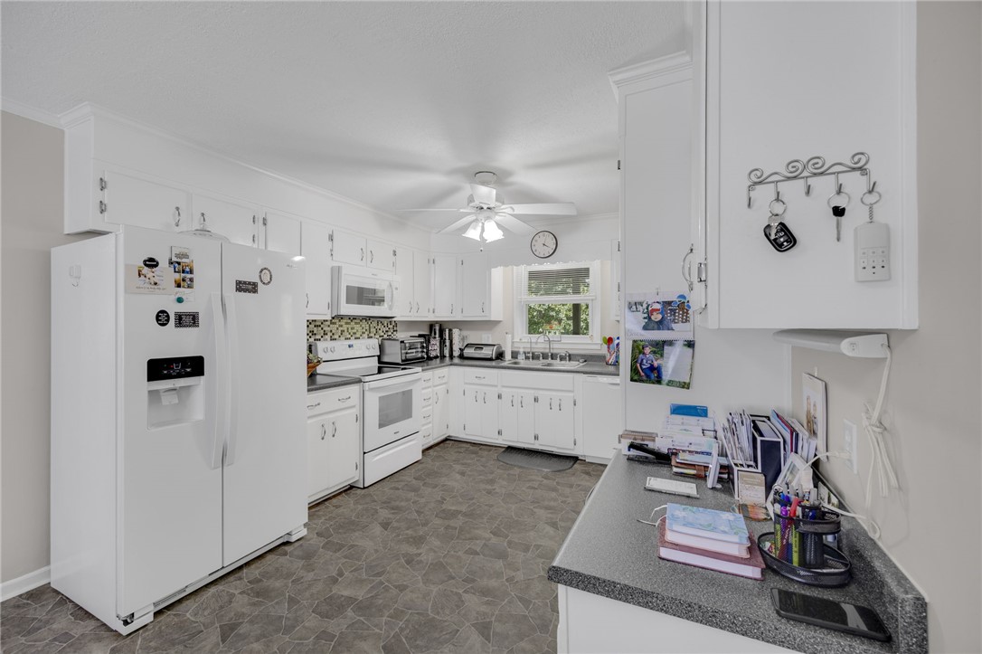 250 Rockcrest Road Cleveland, SC 29635 - Photo 14 of 37 White cabinetry and appliances create a bright and functional kitchen space.