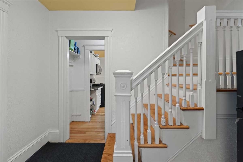 3 Wallace Street Worcester, MA 01605 - Photo 4 of 29 a view of entryway with wooden floor and stairs