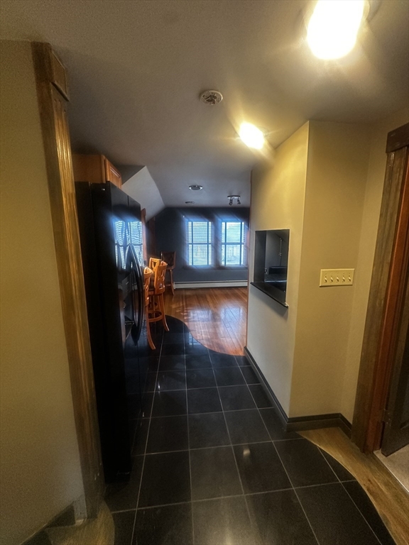 1034 North Main Street, Unit 2 Randolph, MA 02368 - Photo 5 of 14 a hallway with table and chairs