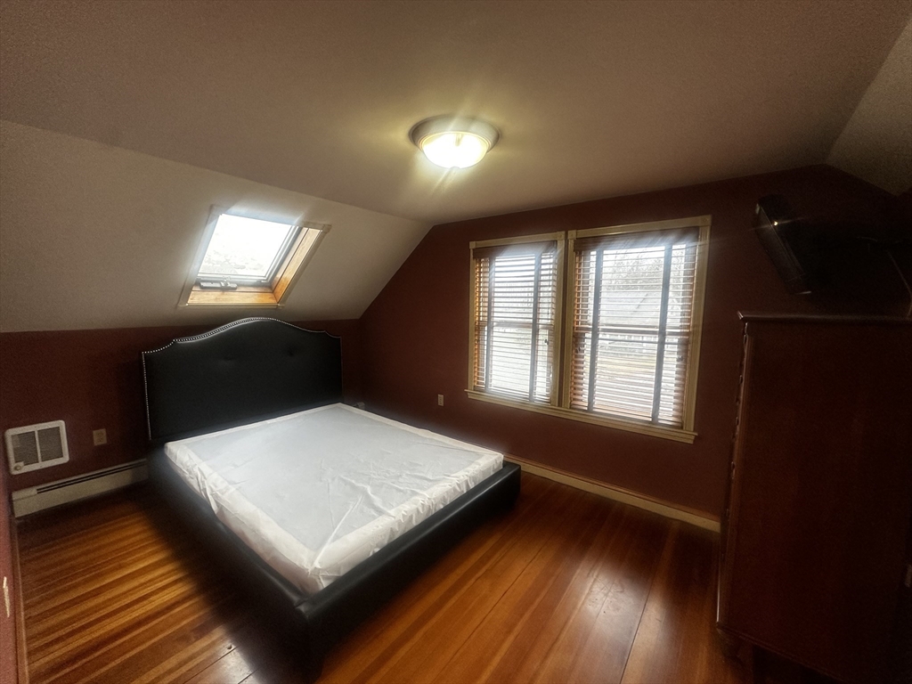 1034 North Main Street, Unit 2 Randolph, MA 02368 - Photo 7 of 14 a living room with hard wood floors and a wooden floor