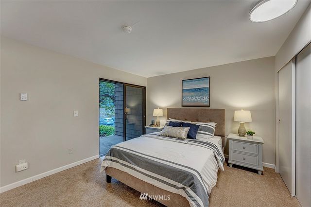 a bedroom with a bed and a lamp