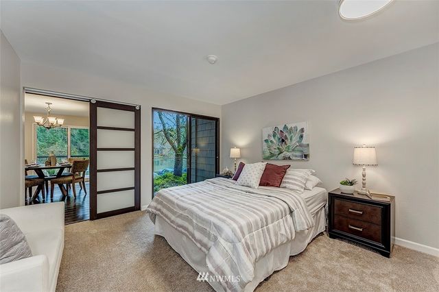 a bedroom with a bed and a lamp