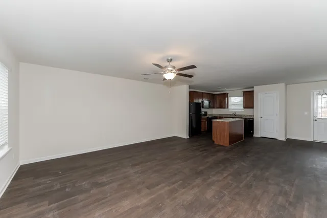 a view of a kitchen with a sink cabinets and wooden floor