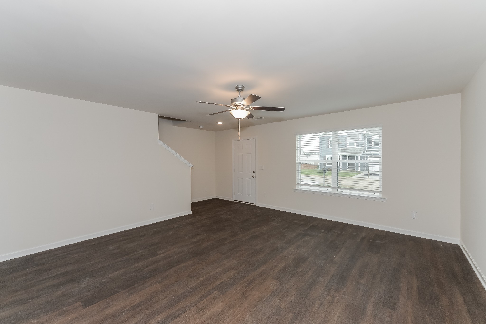 2714 Swarm Court Columbia, TN 38401 - Photo 3 of 17 an empty room with wooden floor chandelier fan and windows