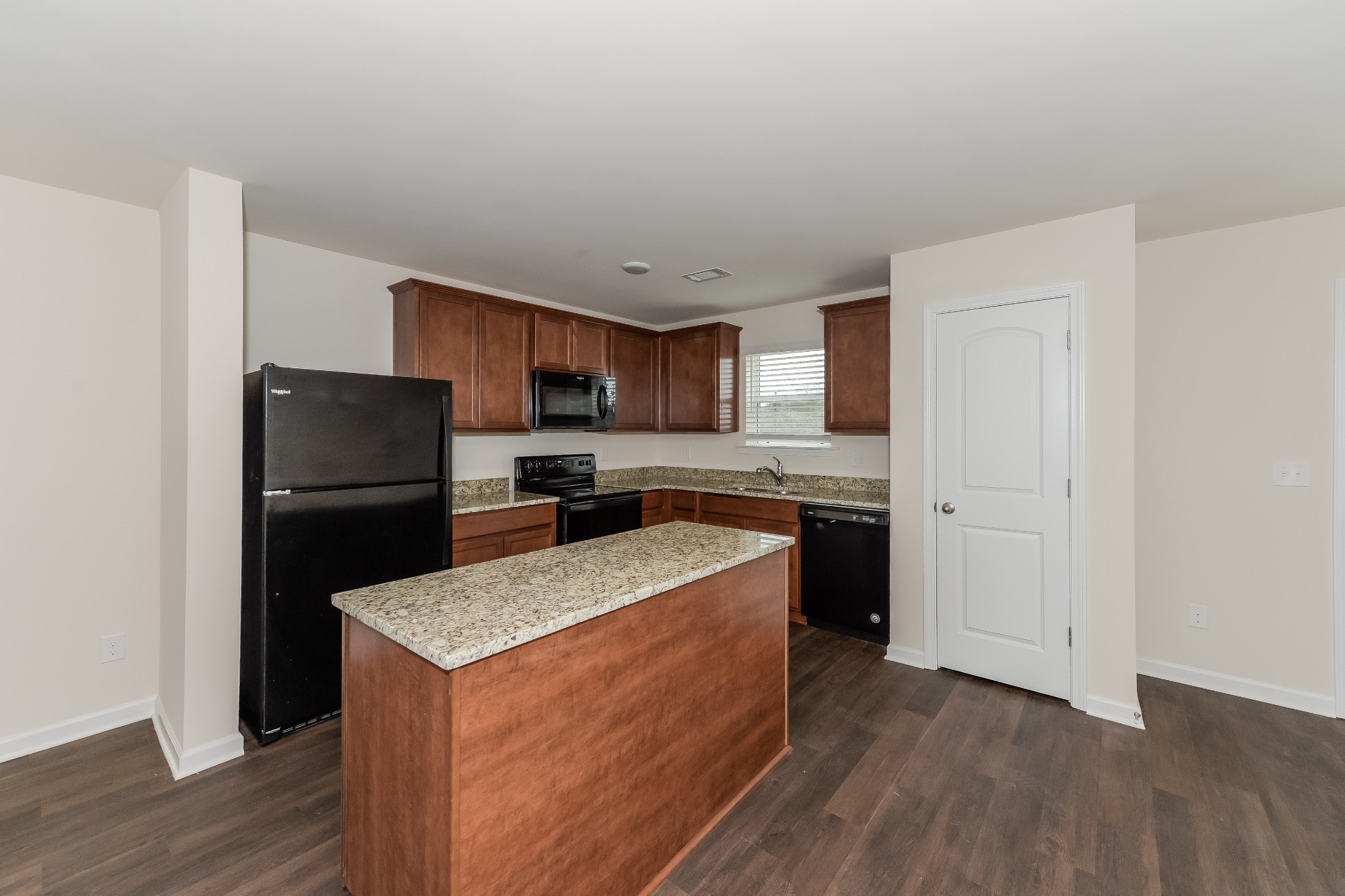 2714 Swarm Court Columbia, TN 38401 - Photo 4 of 17 a kitchen with a refrigerator a stove top oven and wooden floor