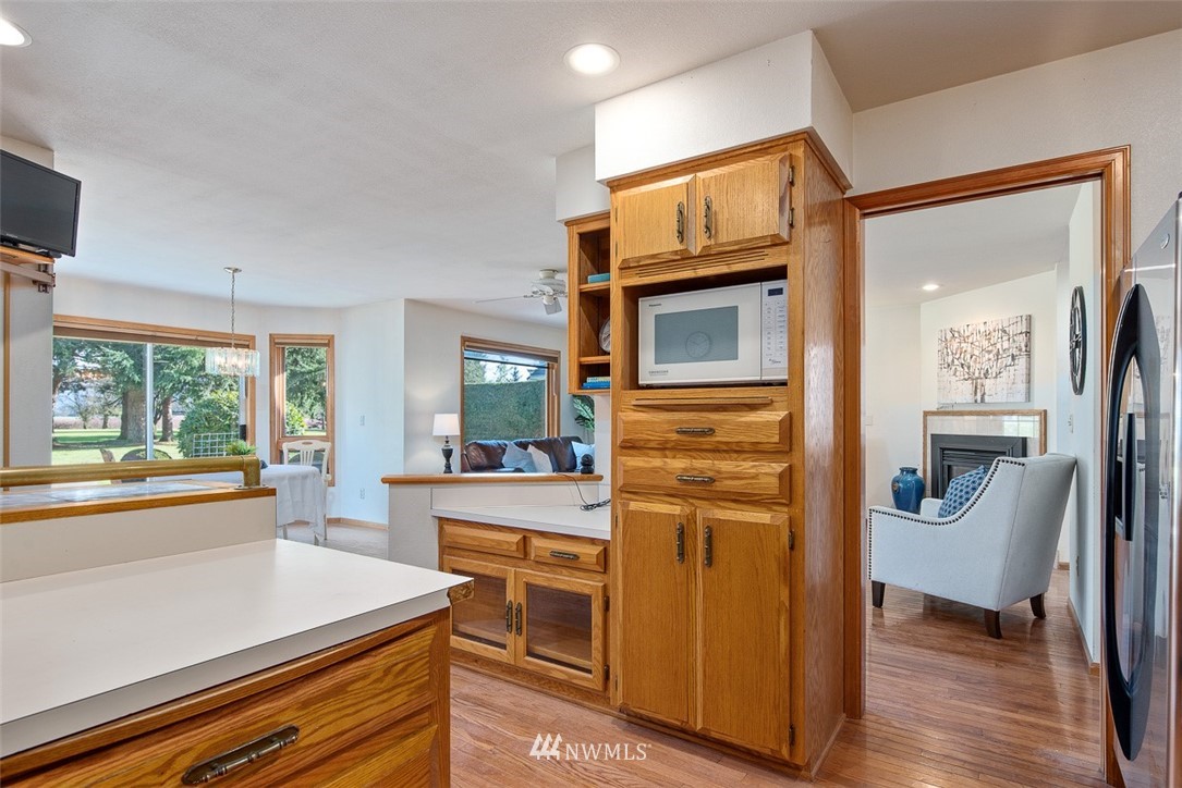 6852A Raspberry Dr., Unit B Everson, WA 98247 - Photo 11 of 25 a kitchen with a refrigerator and a stove top oven