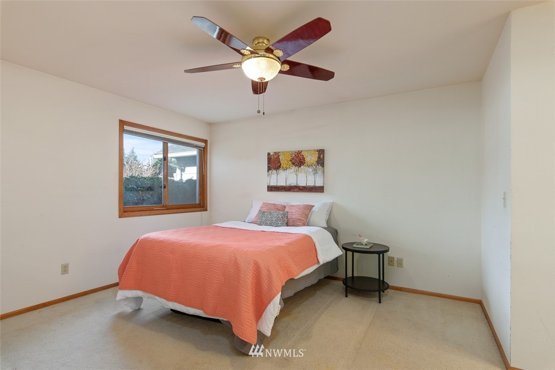 6852A Raspberry Dr., Unit B Everson, WA 98247 - Photo 14 of 25 a bedroom with a bed and a chandelier