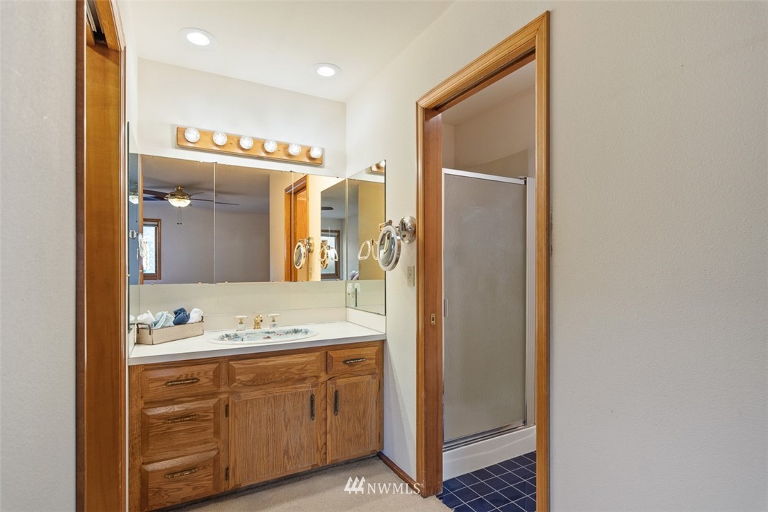 6852A Raspberry Dr., Unit B Everson, WA 98247 - Photo 15 of 25 a bathroom with a sink a mirror and a shower