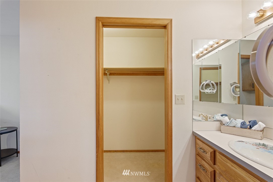 6852A Raspberry Dr., Unit B Everson, WA 98247 - Photo 16 of 25 a bathroom with a granite countertop sink and a mirror