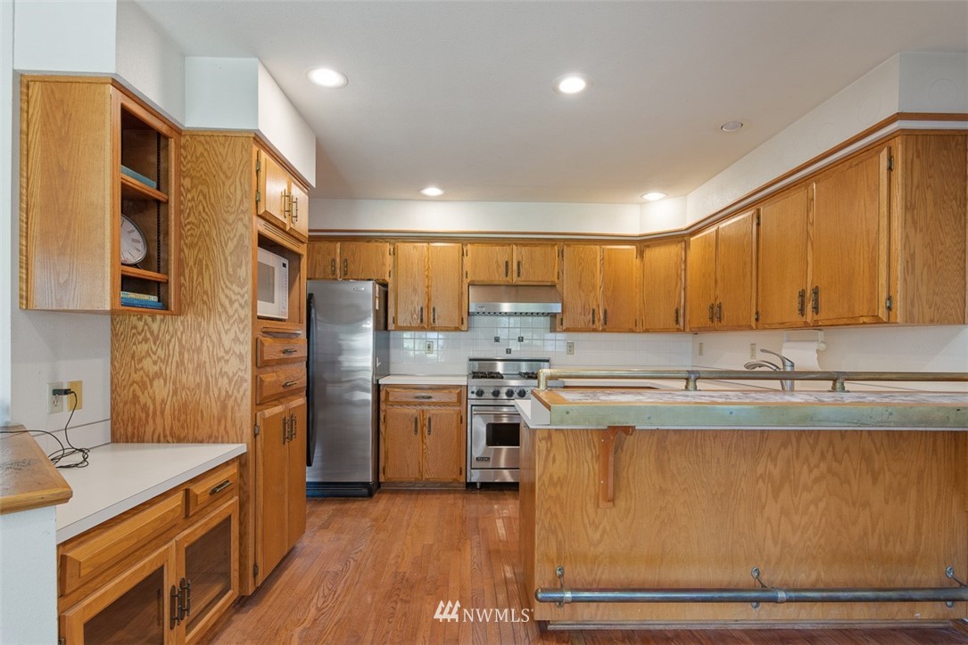 6852A Raspberry Dr., Unit B Everson, WA 98247 - Photo 9 of 25 a kitchen with kitchen island granite countertop a sink cabinets and stainless steel appliances