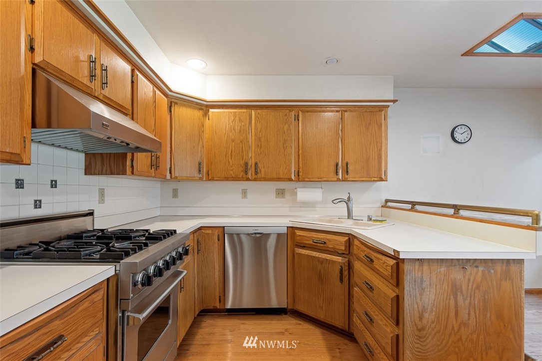 6852A Raspberry Dr., Unit B Everson, WA 98247 - Photo 10 of 25 a kitchen with a sink stove top oven and cabinets