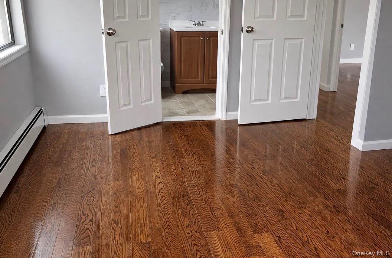 235-15 Bentley Road Queens, NY 11422 - Photo 13 of 17 a view of a hallway with wooden floor
