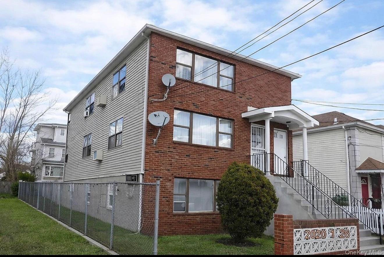 235-15 Bentley Road Queens, NY 11422 - Photo 17 of 17 a front view of a house with a garden