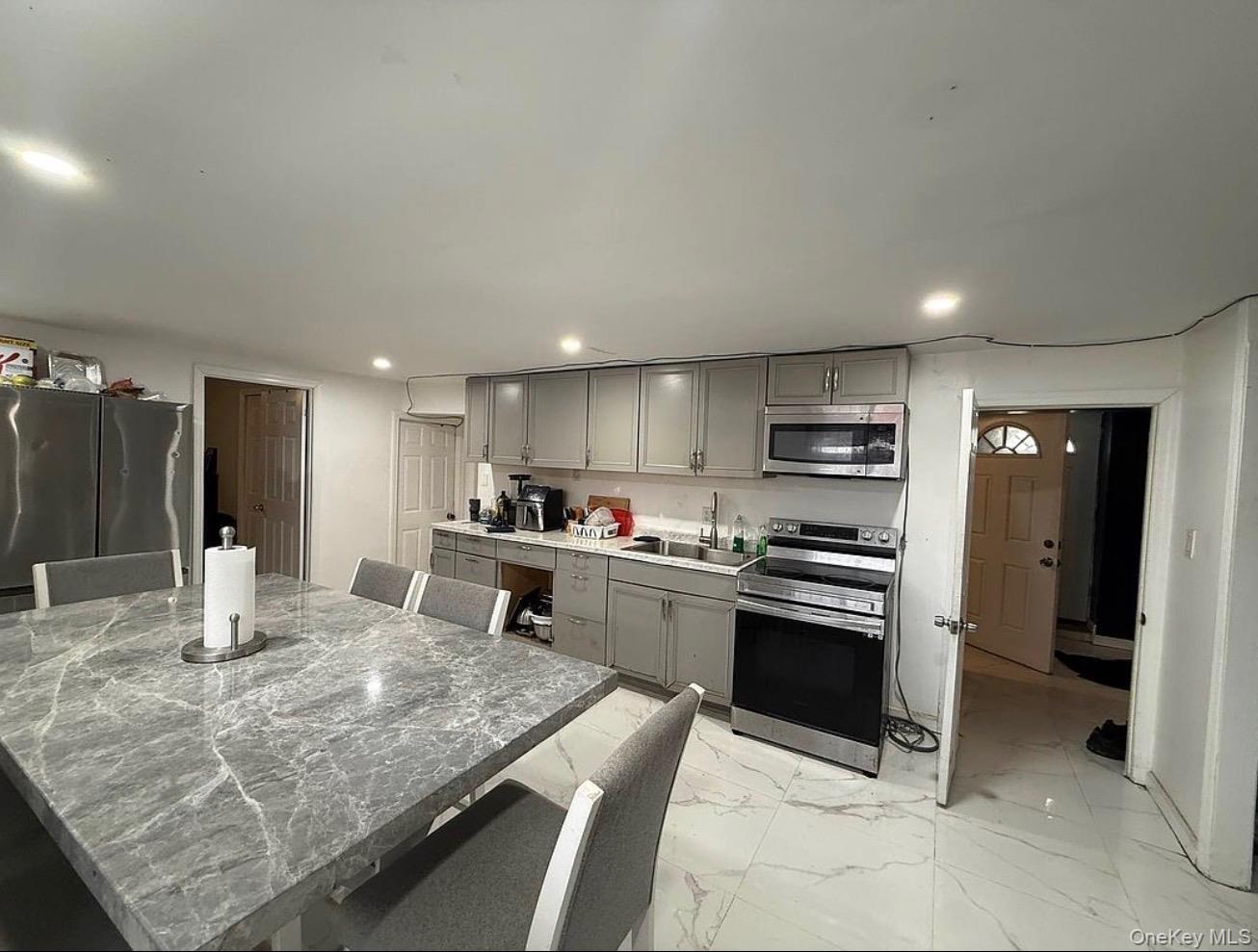 235-15 Bentley Road Queens, NY 11422 - Photo 7 of 17 a kitchen with stainless steel appliances granite countertop a sink counter space and cabinets