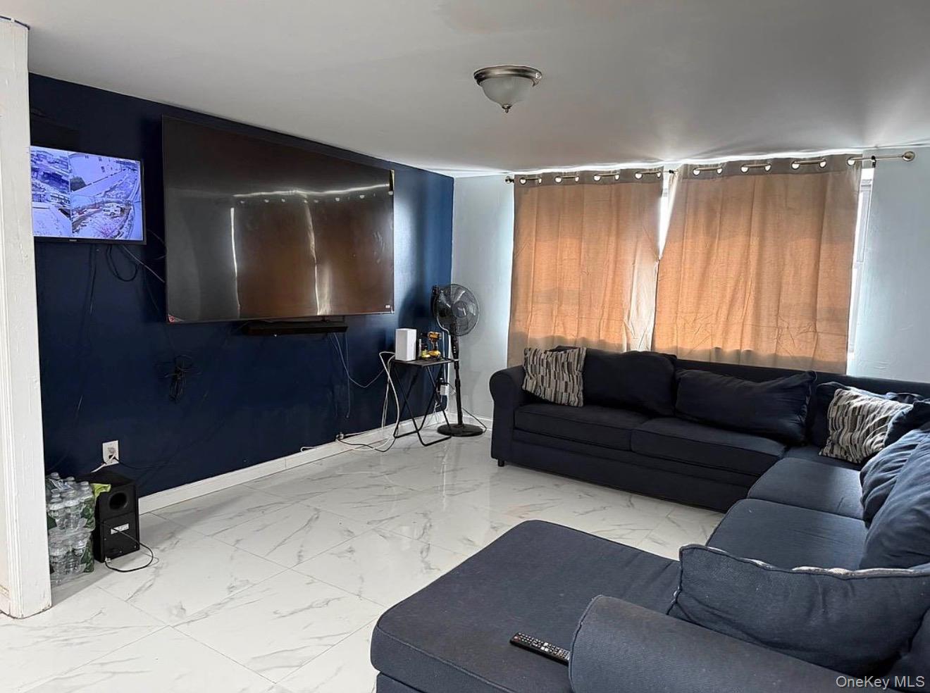 235-15 Bentley Road Queens, NY 11422 - Photo 8 of 17 a living room with furniture and a flat screen tv