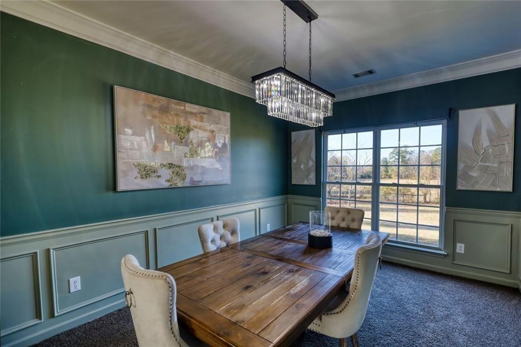 25 Caseys Way Covington, GA 30014 - Photo 11 of 33 a view of a dining room with furniture wooden floor and chandelier