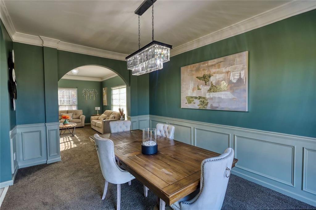 25 Caseys Way Covington, GA 30014 - Photo 13 of 33 a view of a dining room with furniture a chandelier and wooden floor