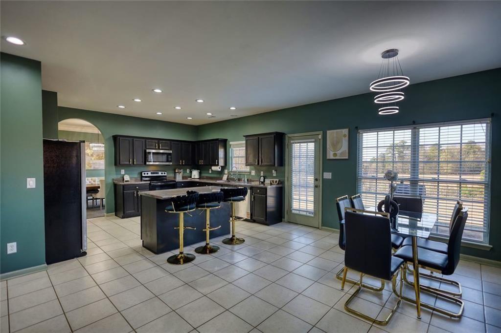 25 Caseys Way Covington, GA 30014 - Photo 16 of 33 a kitchen with a sink and chairs