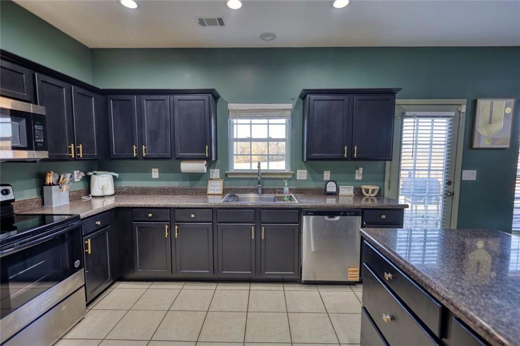 25 Caseys Way Covington, GA 30014 - Photo 17 of 33 a kitchen with a sink stove top oven and cabinets