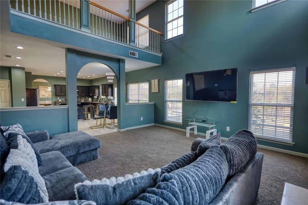 25 Caseys Way Covington, GA 30014 - Photo 18 of 33 a living room with furniture and a flat screen tv