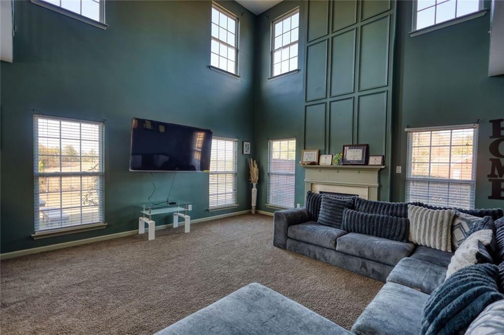 25 Caseys Way Covington, GA 30014 - Photo 20 of 33 a living room with furniture and a flat screen tv