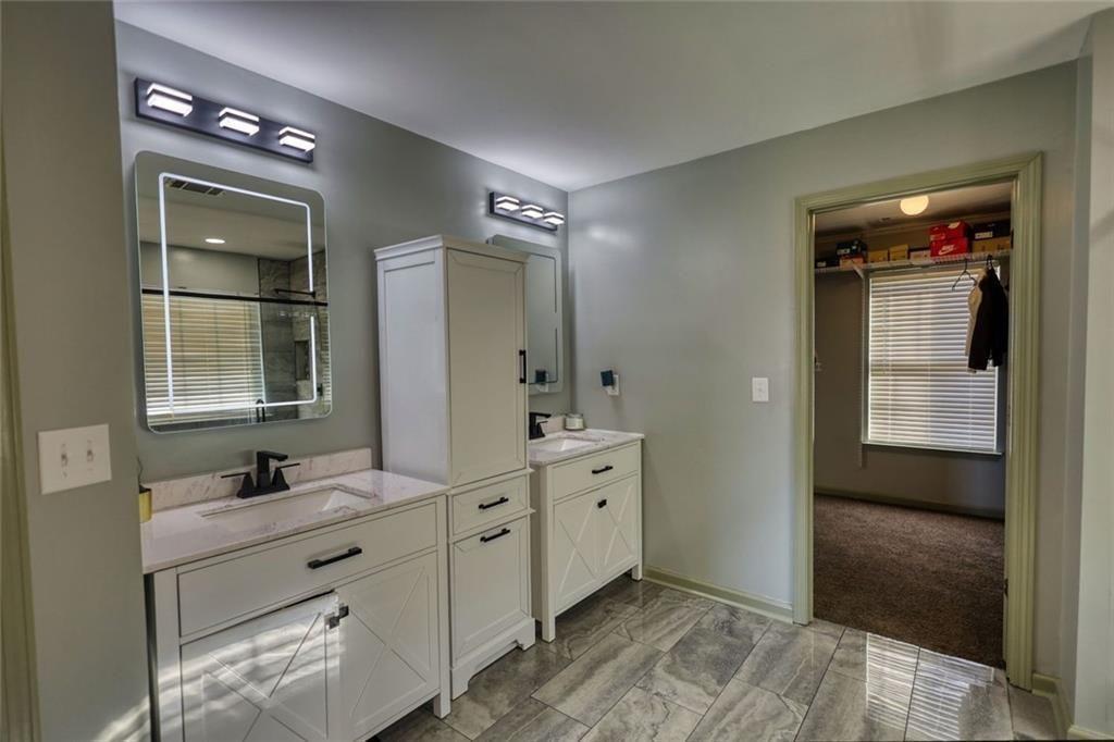 25 Caseys Way Covington, GA 30014 - Photo 26 of 33 a spacious bathroom with a double vanity sink and a mirror