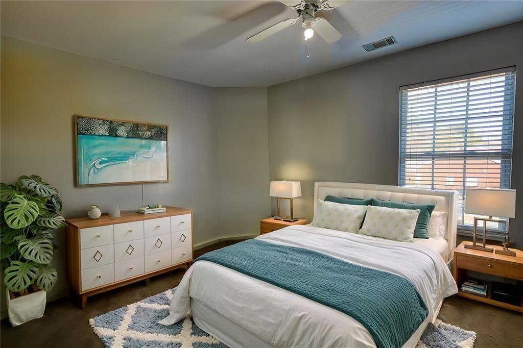 25 Caseys Way Covington, GA 30014 - Photo 28 of 33 a bedroom with a bed and a chandelier